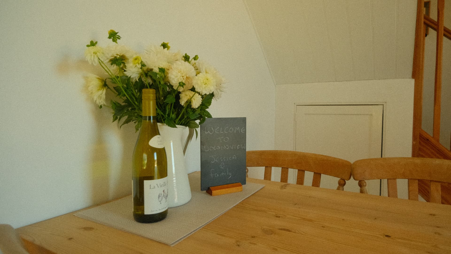 A welcome chalkboard, flowers and a bottle of wine on arrival