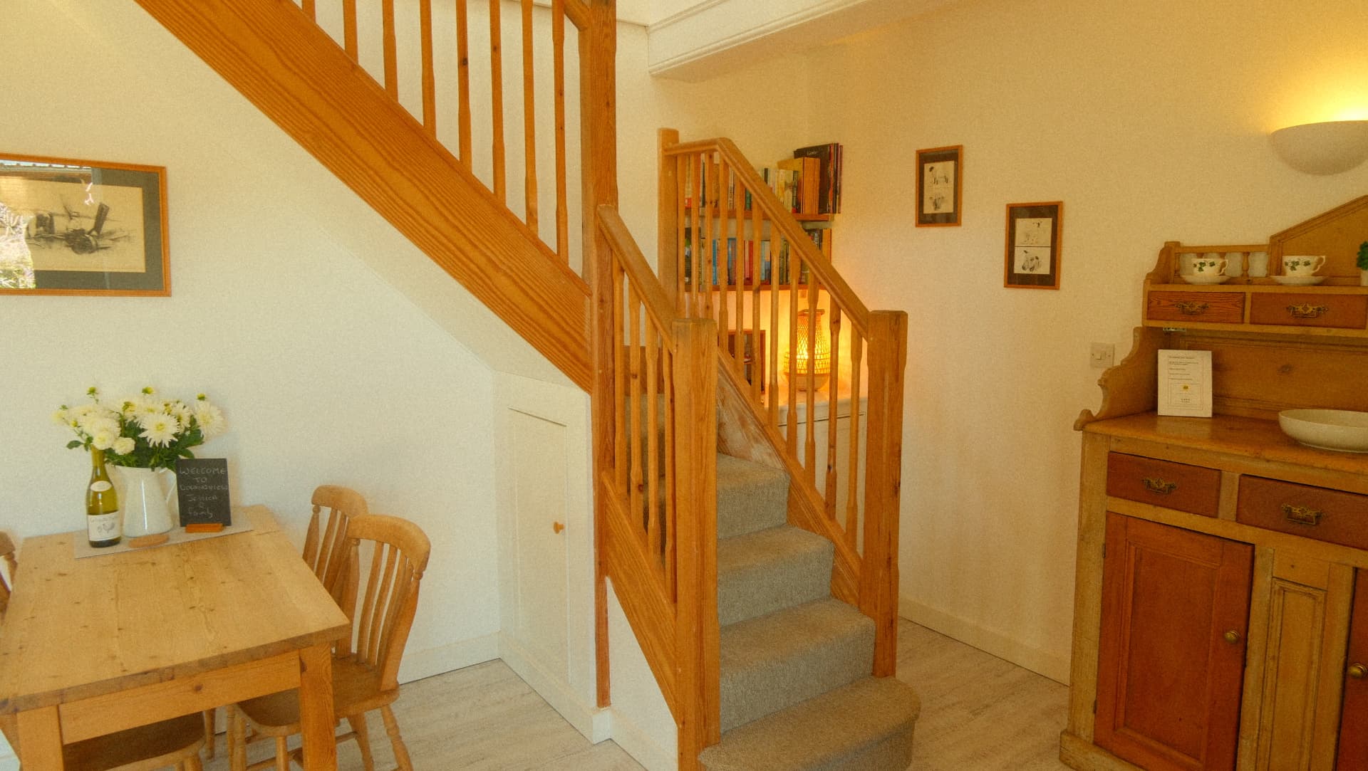 The dining area and staircase, with the welcome chalkboard