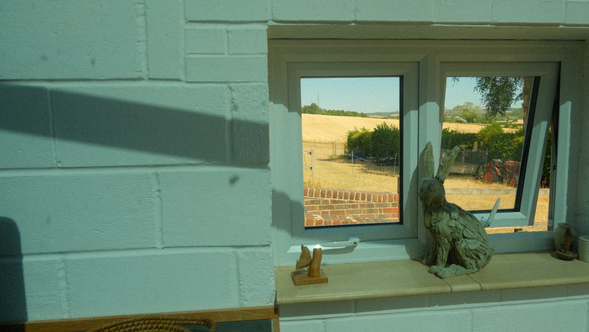 Field views from the window, with a hare on the sill