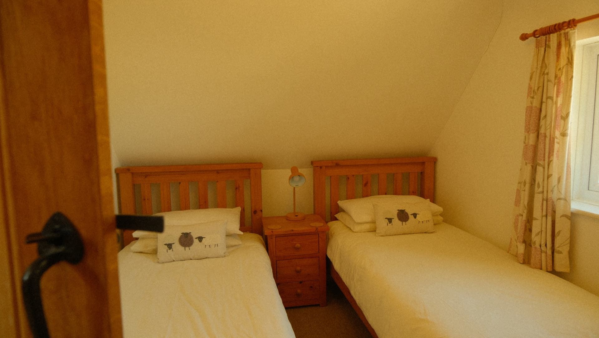 Twin beds beneath the sloping eaves