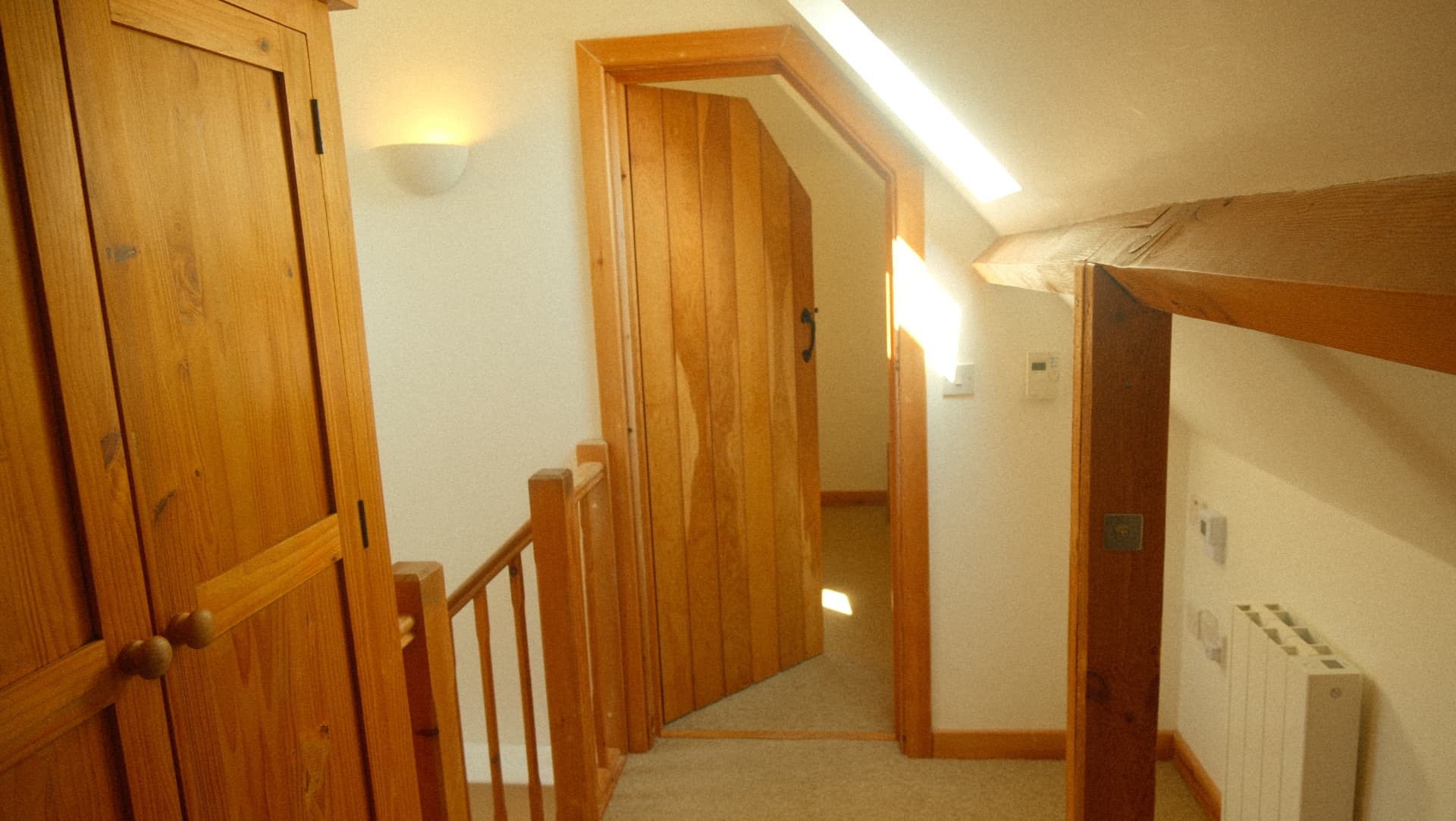 The upstairs landing with pine doors and beams